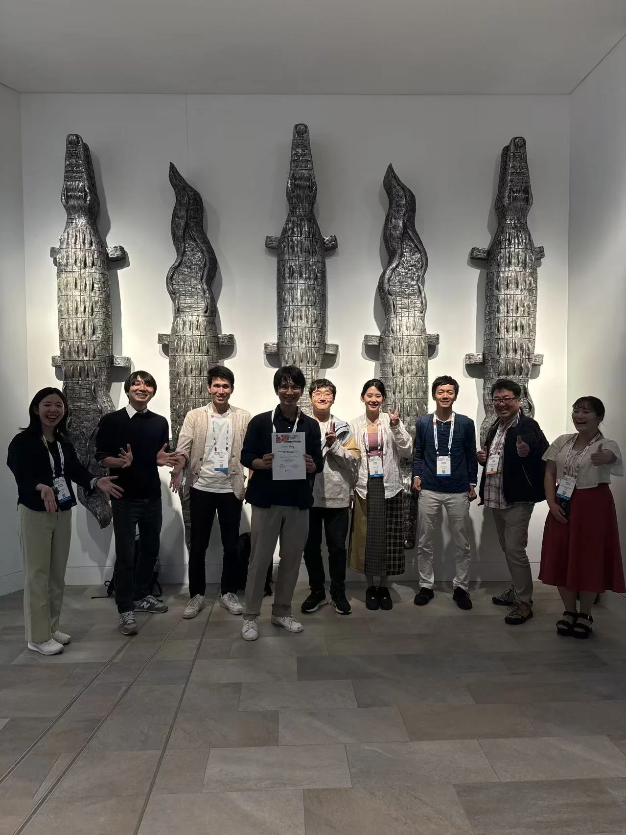 Nine Viruses of Microbes 2024 attendees posing in front of crocodile sculptures in Cairns.