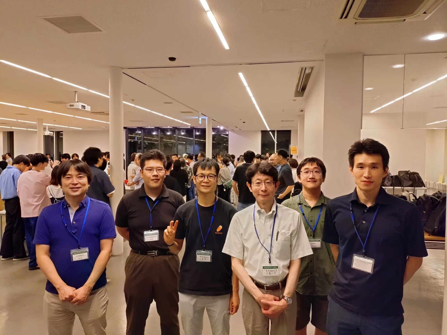 Six attendees pose together at an evening reception during the evolution meeting in Nagoya.